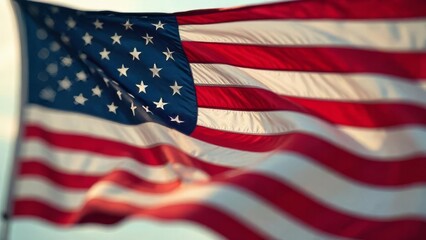 Obraz premium American flag waving against blue sky. USA celebrates Independence day. Fourth of july national holiday. Patriotic symbol.