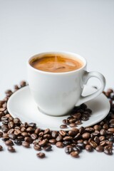Fototapeta premium A cup of steaming coffee surrounded by coffee beans 