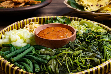 Traditional Indonesian Pecel Ingredients on a Rattan Tray