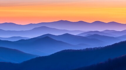 Fototapeta premium Colorful sunrise over a misty mountain range.
