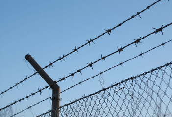 A fence with barbed wire on top of it