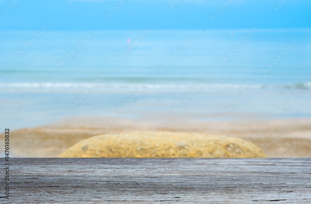 Poster wood floor counter top there is a view of sea in the background of the resort. a blurry beach and sk