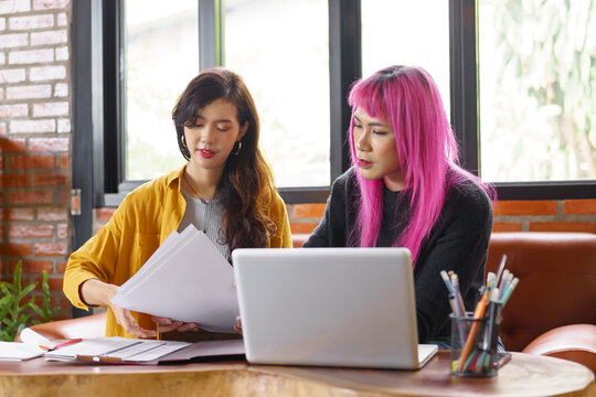 LGBTQ+ transgender man Beautiful Authentic Specialist&nbsp;with Pink Hair and Non-binary trans working together Working Design in creative workplace team work colleagues Gender equality