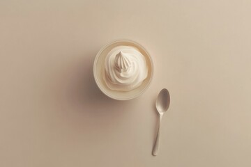 detailed color picture of flat lay of a cream and spoon on plain background