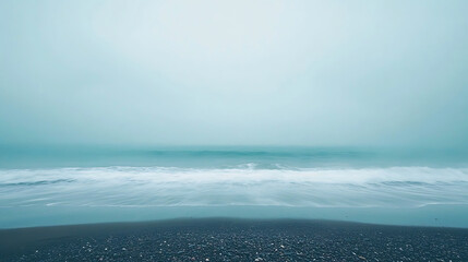 Misty Ocean Beach with Dark Sand.
