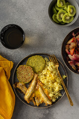A savory, balanced breakfast with turmeric rice, baked ocean fish, broccoli pancakes, and roasted vegetable salad, providing essential proteins and healthy fats for an energizing start