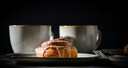 Cinnamon rolls on plates with coffee