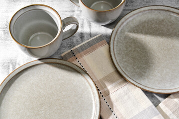 Empty plates and coffee mugs on table