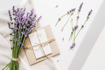 Elegant lavender-themed set with invitation, envelope tied with ribbon, and loose lavender sprigs.