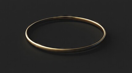 Smooth, gold-toned bangle resting on a dark background.