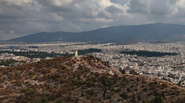 ZOOM OUT of the Parthenon and Philopappos park. Was built on the Acropolis in Athens between 447 and 432 BC. It served as a treasury for the Delian League and a symbol of Athens's power and influence.