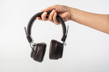 HeadPhones in hand, Headphones isolate on white. Wireless headphones in brown.