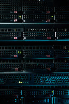 Rows of computer servers in modern data center environment with LED indicators glowing and various server components visible showcasing advanced technology and infrastructure