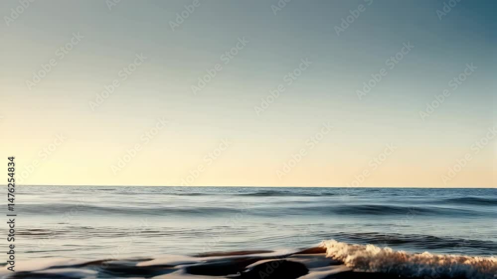 Poster abstract ocean waves gently roll with a golden glow on the surface, reflecting the evening light in 