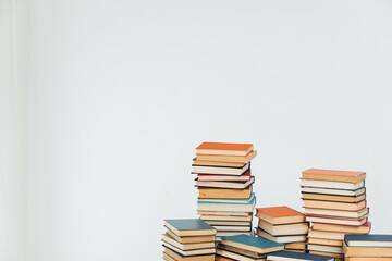 Stacks of educational books for learning on a white background