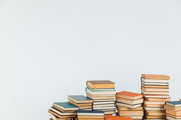 Stacks of educational books for learning on a white background