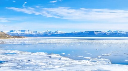 Lake Baikal in May, viewed from Olkhon Island, with small ice floes on the lake. Spring landscape with distant mountains and natural ice formations, capturing the changing season and spring travel vib