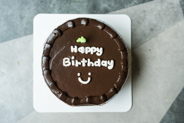 Chocolate birthday cake with happy birthday message on top. Top view