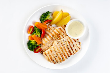 Healthy food, high protein, low fat, grilled chicken breast and broccoli, lettuce on a white plate,...