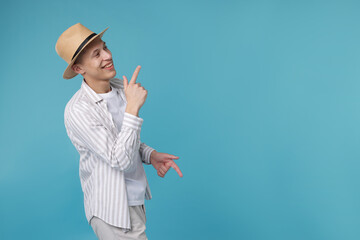 Happy man dancing on light blue background. Space for text