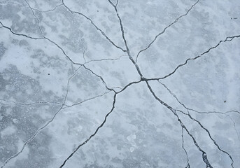 Ice-Covered Road Surface with Cracked Traffic Veins Visible