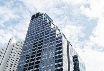 Bottom up view tower building with blue sky background