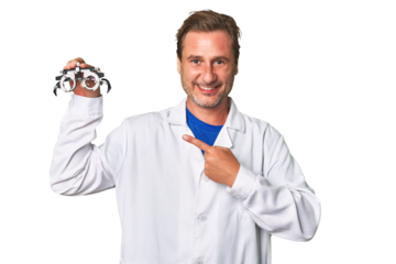 A middle-aged optometrist man smiling and pointing aside, showing something at blank space.