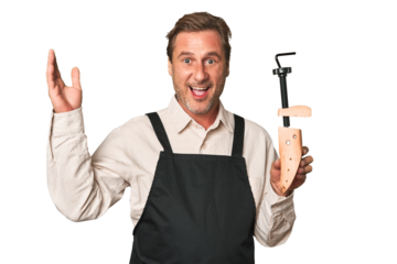 A middle-aged shoe maker receiving a pleasant surprise, excited and raising hands.