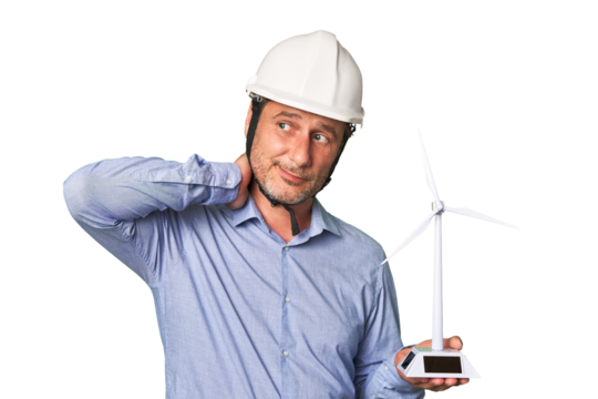 A middle-aged architect man holding a windmill model touching back of head, thinking and making a choice.