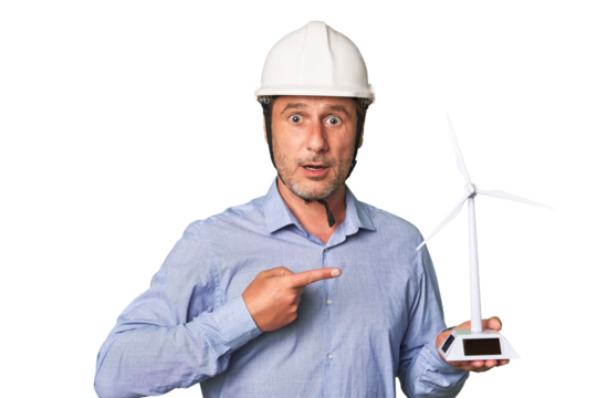 A middle-aged architect man holding a windmill model pointing to the side