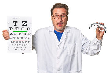 Experienced optometrist conducts eye exam with care, holding visual acuity test and prescription...