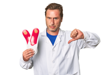 A middle-aged podiatrist holding an insoles