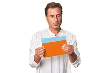 Middle-aged gentleman captivated by letter in this pensive studio portrait, exuding sincerity and depth.