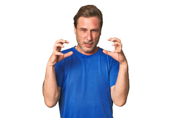 A middle-aged man isolated screaming with rage.