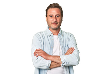A middle-aged man isolated who feels confident, crossing arms with determination.