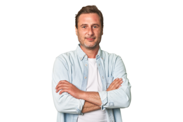 A middle-aged man isolated who feels confident, crossing arms with determination.