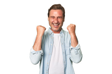 Fototapeta na wymiar A middle-aged man isolated cheering carefree and excited. Victory concept.