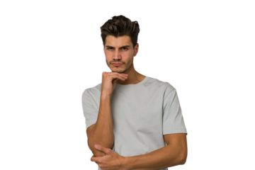 Young handsome caucasian man isolated on white background suspicious, uncertain, examining you.