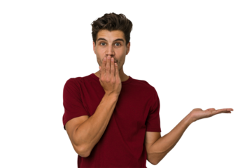 Young handsome caucasian man isolated on white background impressed holding copy space on palm.