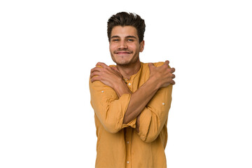 Young handsome caucasian man isolated on white background hugs, smiling carefree and happy.