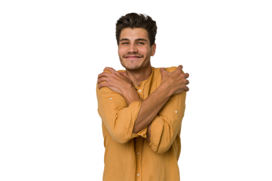 Young handsome caucasian man isolated on white background hugs, smiling carefree and happy.
