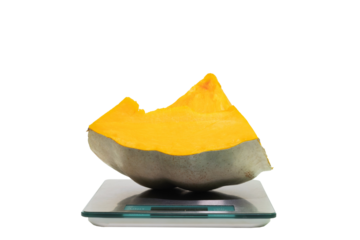 a piece of pumpkin on a digital scale, food safety concept