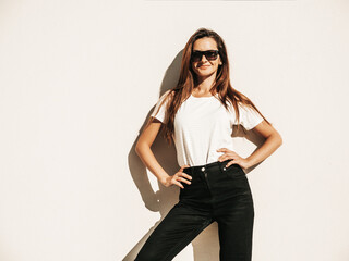 Portrait of beautiful model in sunglasses. Female dressed in summer hipster white T-shirt and...