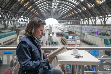 Woman Making a Coffee Break in Railway Station in Milan, Lombardy, Italy.