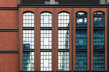 Obraz premium Vintage Brick Building with glass windows - Modern Architecture with Vintage Inspiration