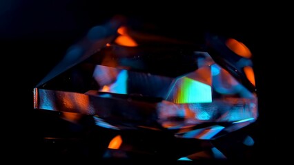 Vivid Colors Reflecting on Faceted Crystal in Darkness