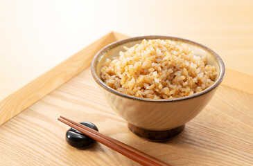 Freshly Cooked Brown Rice on a Wooden Table with Chopsticks