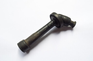 A black colored spark plug shell isolated on a white background