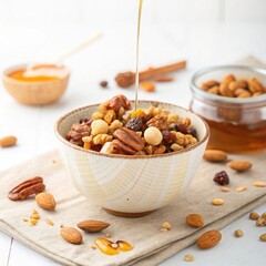 Honey drizzled over a bowl of mixed nuts and dried fruits a healthy breakfast option