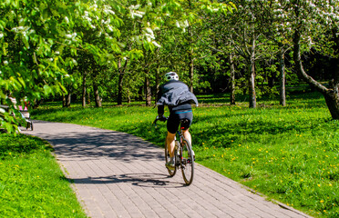 Cyclist ride on the bike path in the city Park
